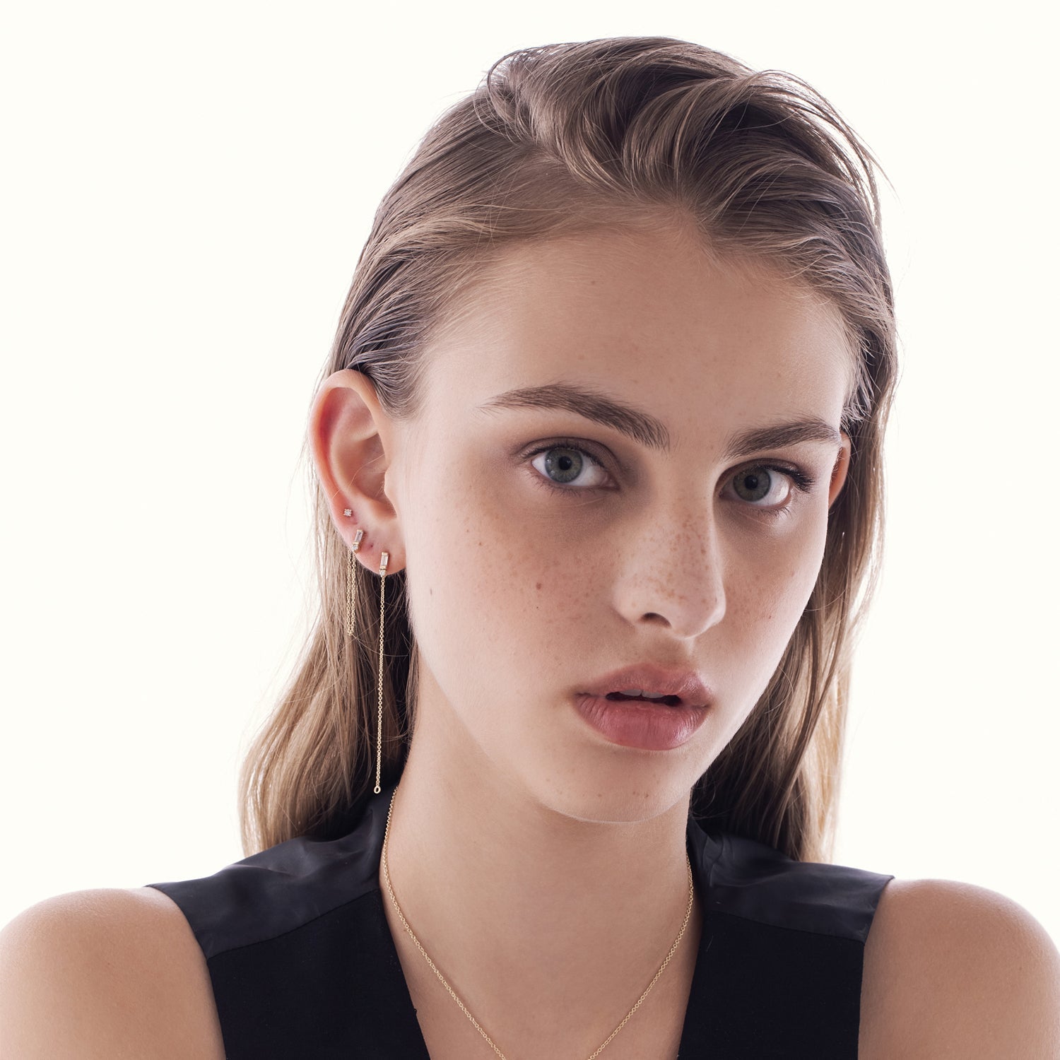 A special gold chain earring set with lab diamonds in a baguette and circle cut