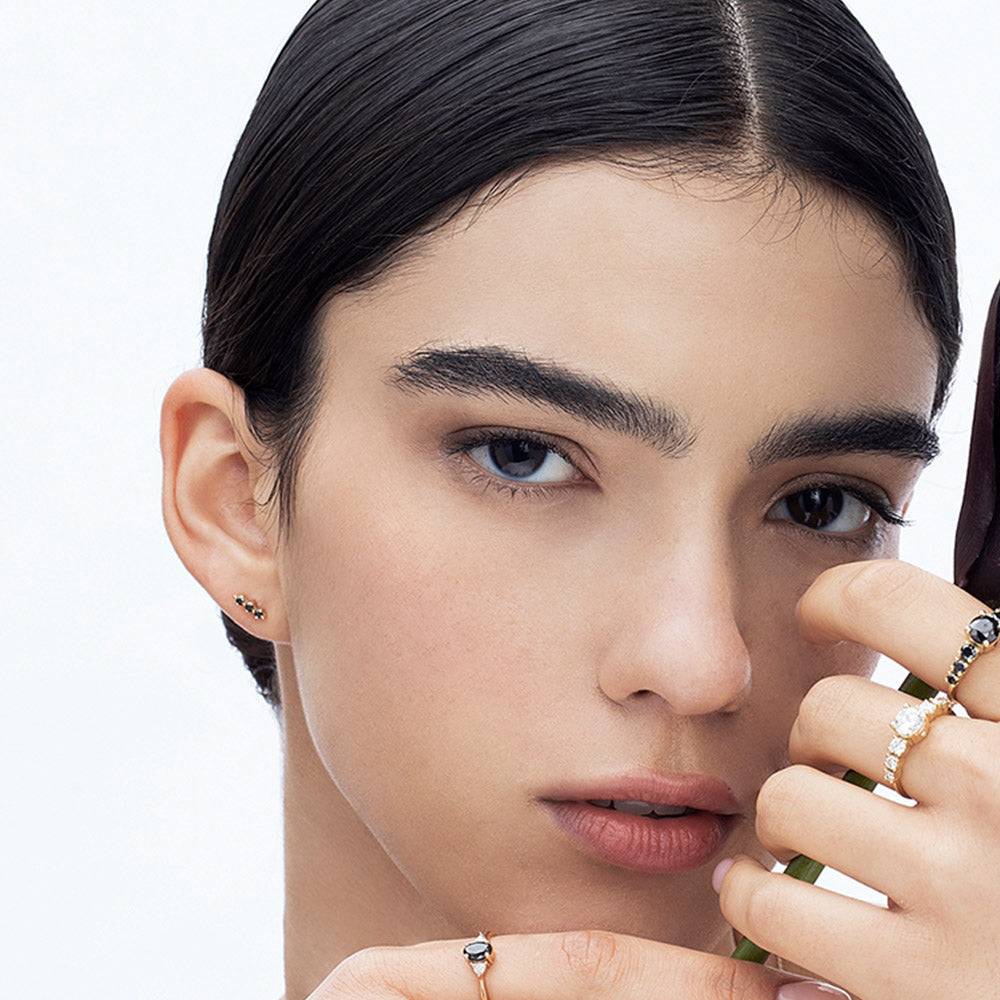 Tight gold earrings set with 3 black diamonds