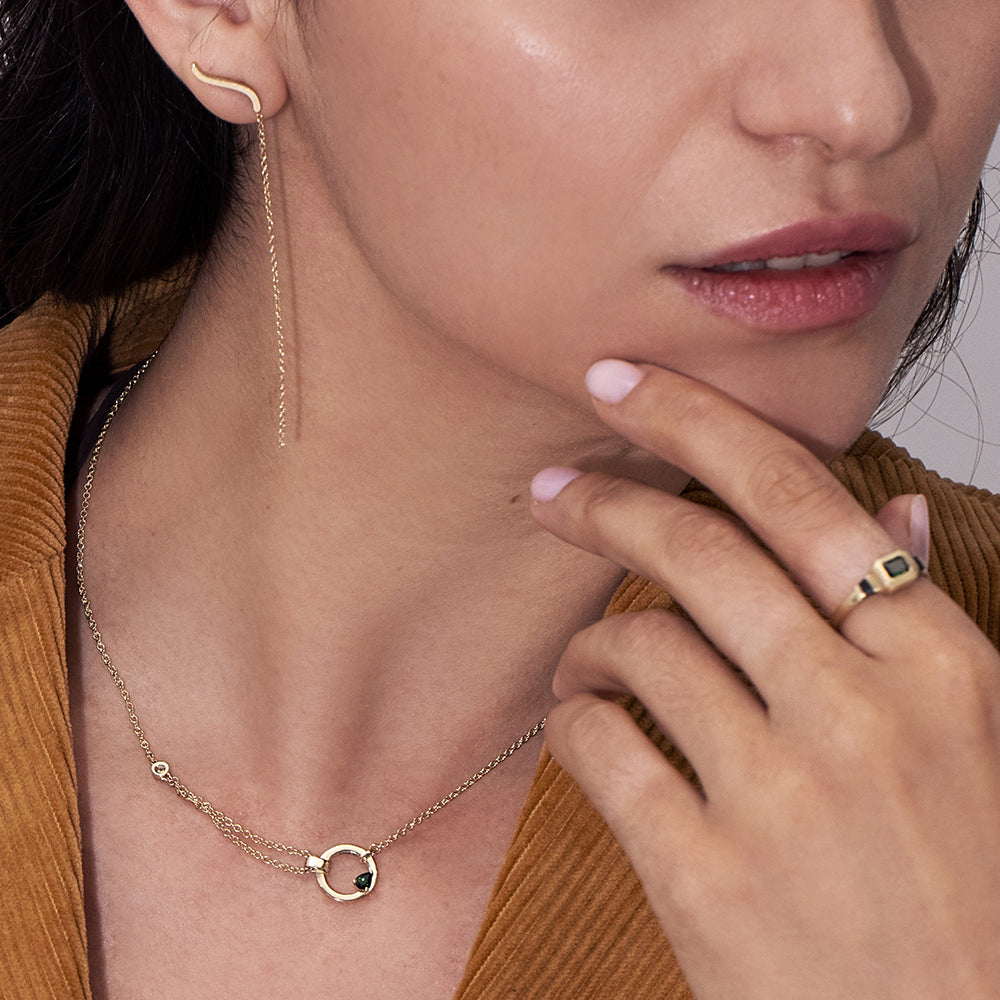 A thick, asymmetric and special gold chain, with a modern and impressive design. Set with tourmaline and diamond