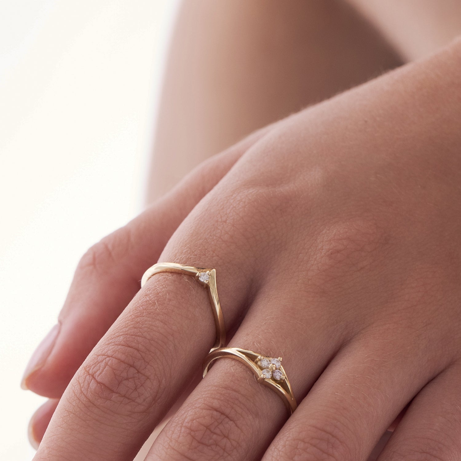 V-shaped gold ring set with a white diamond