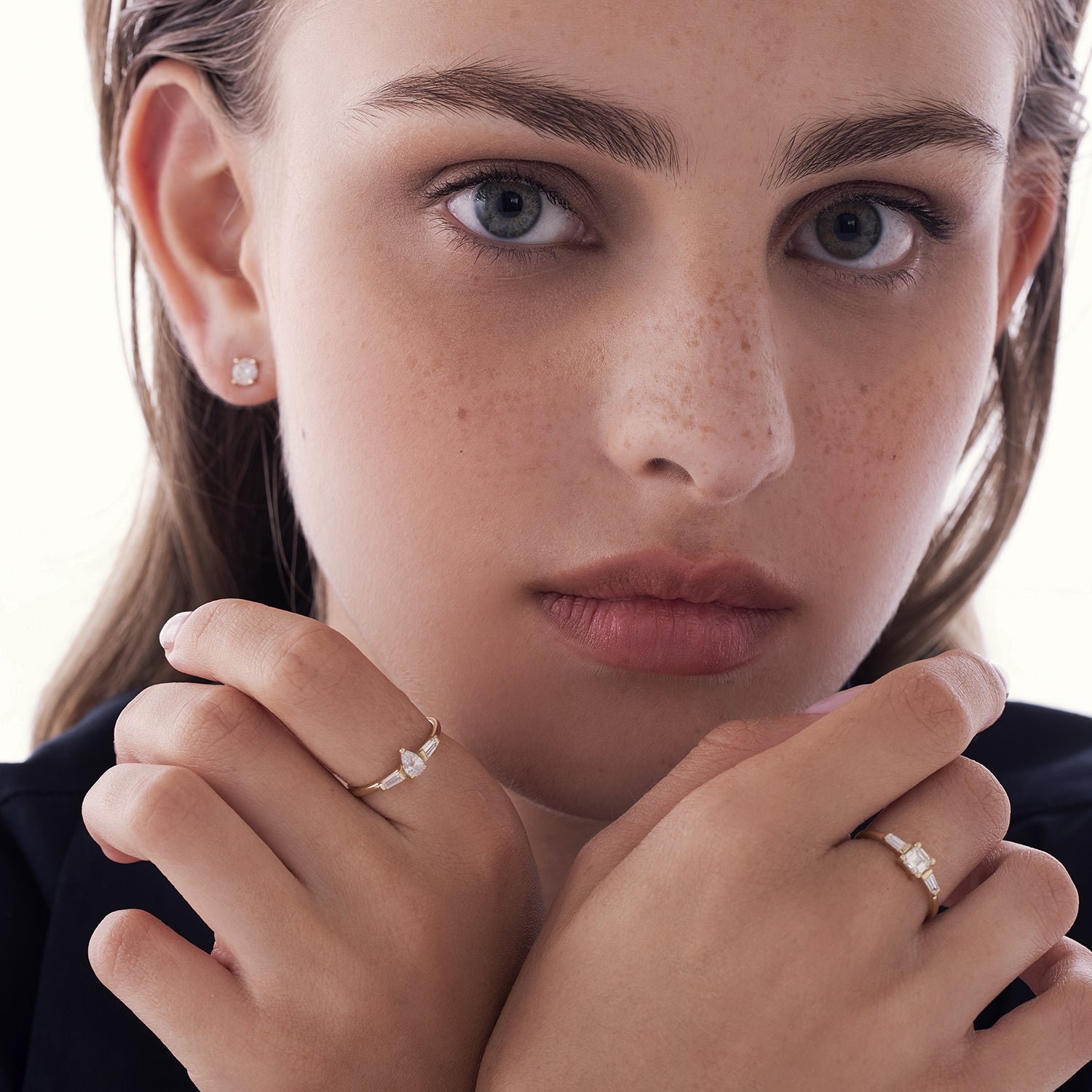 A geometric gold ring set with drop-cut natural diamonds and claws