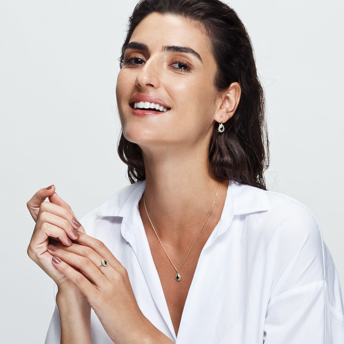 A classic gold ring set with drop-shaped sapphires and diamonds all around