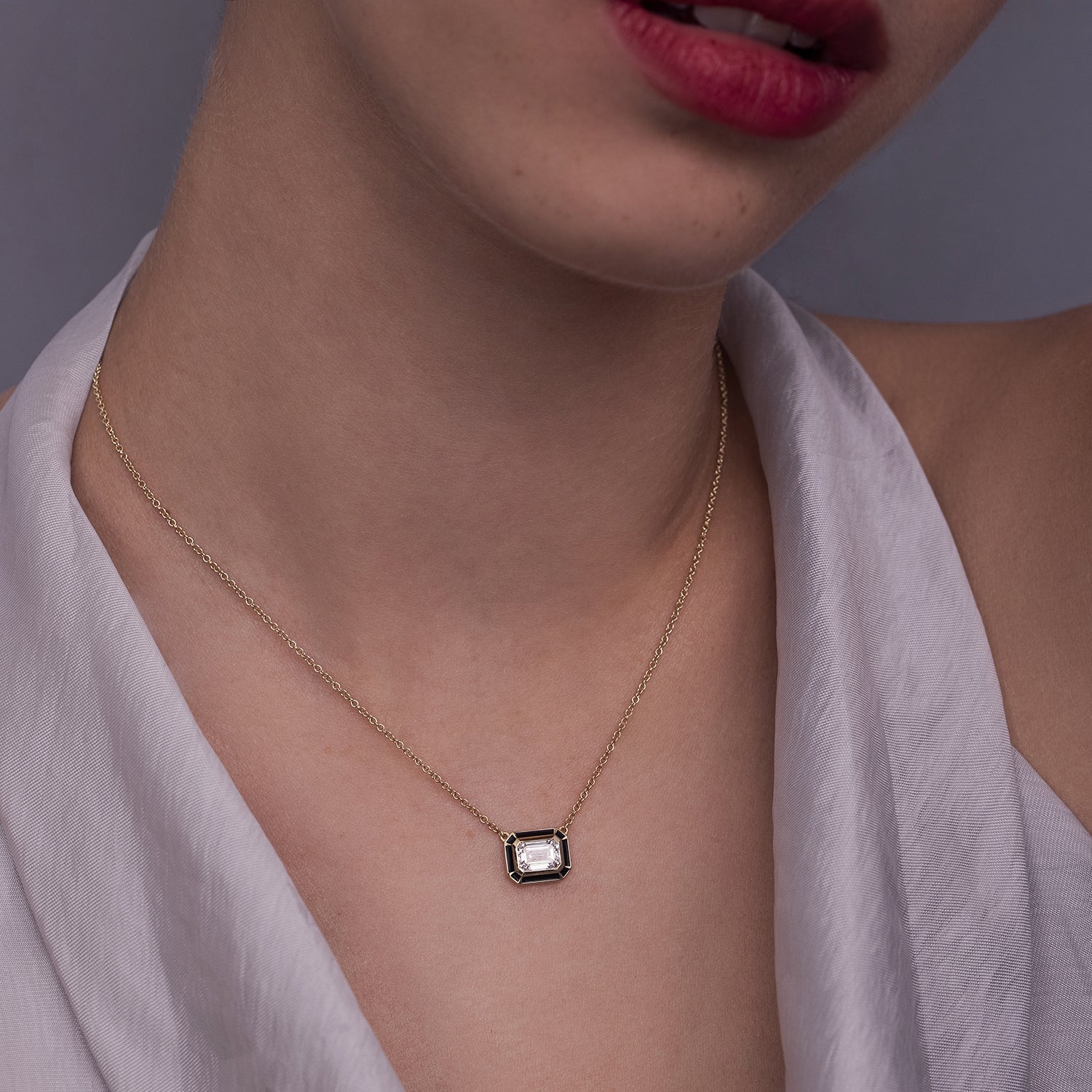 A special classic gold necklace with a 1 carat emerald cut laboratory diamond in a special enamel frame