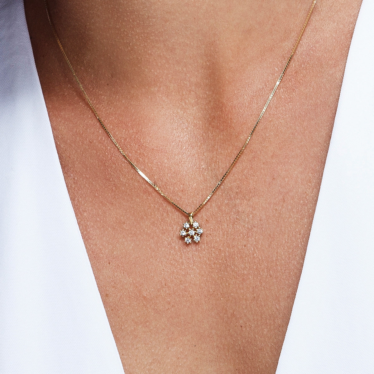 Gold chain and snowflake pendant studded with diamonds