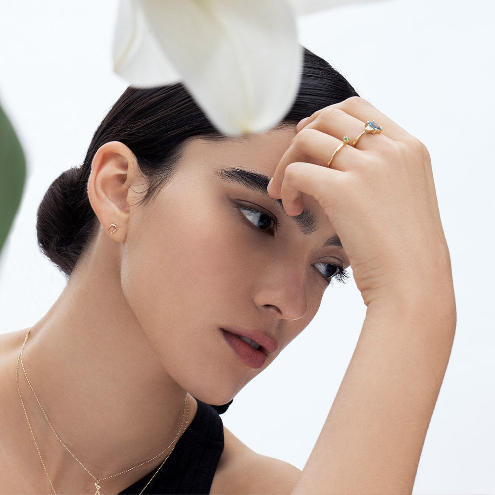 Small tight gold earrings in the shape of a horseshoe