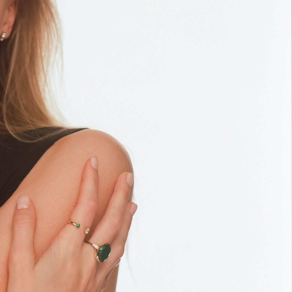 An impressive green onyx ring with an oval cut and laboratory diamonds