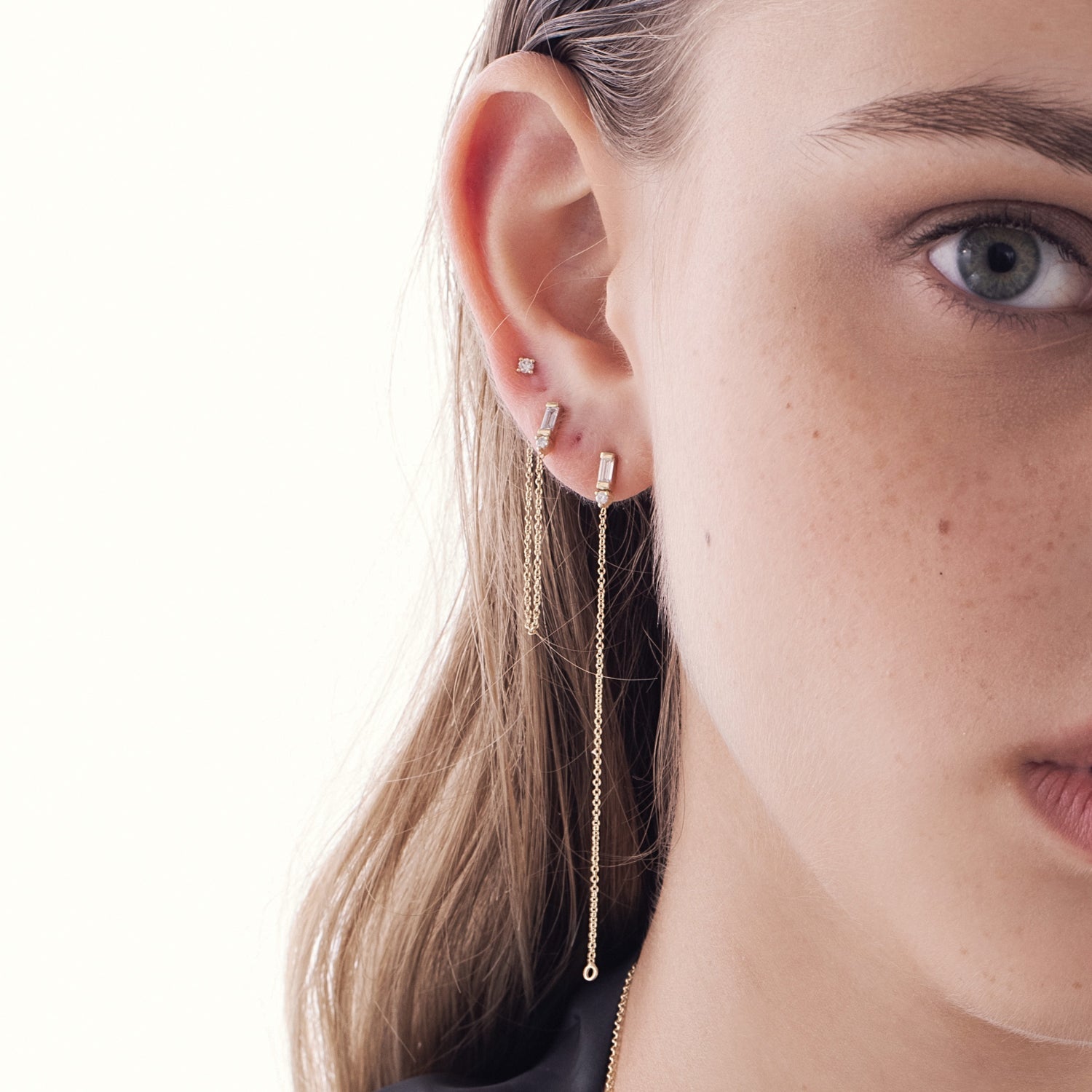 A special gold chain earring set with lab diamonds in a baguette and circle cut