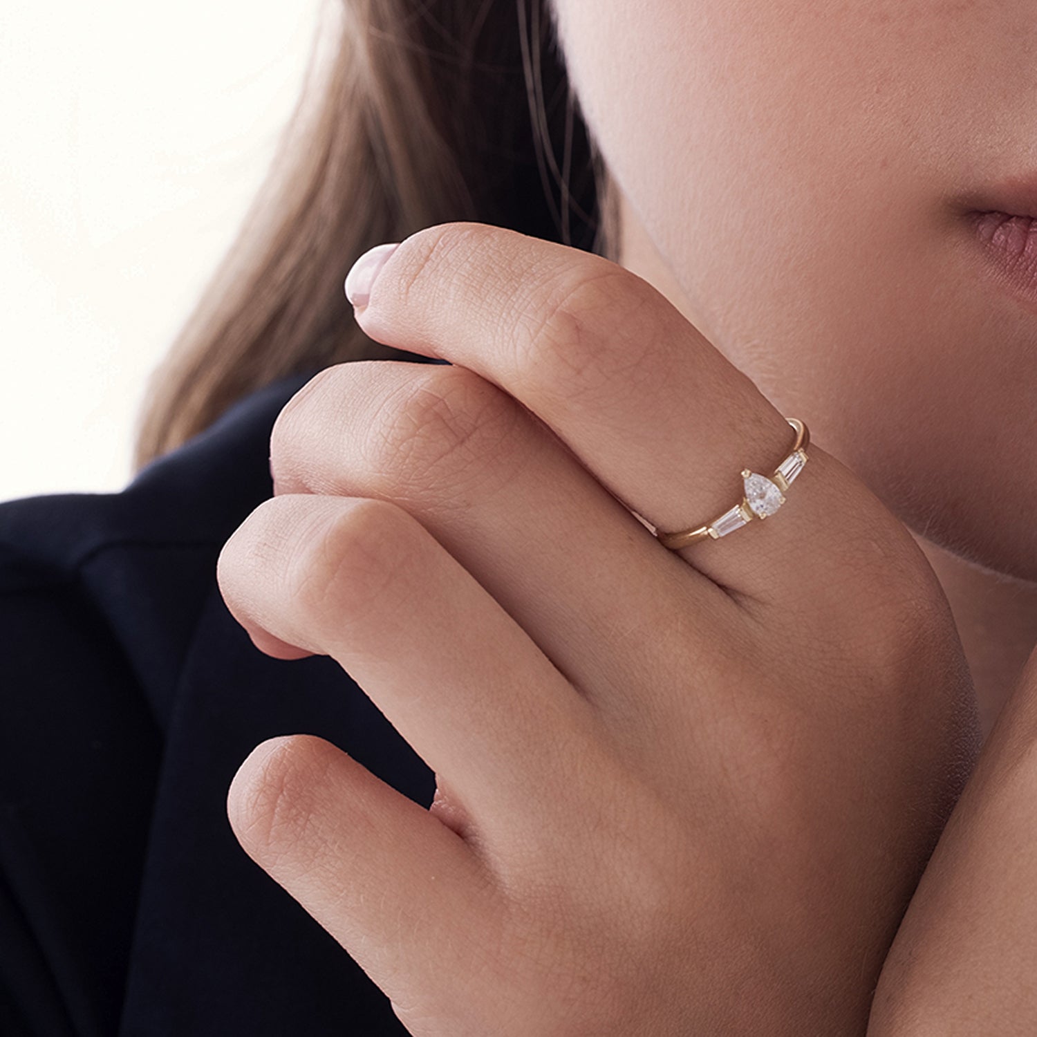 A geometric gold ring set with drop-cut natural diamonds and claws