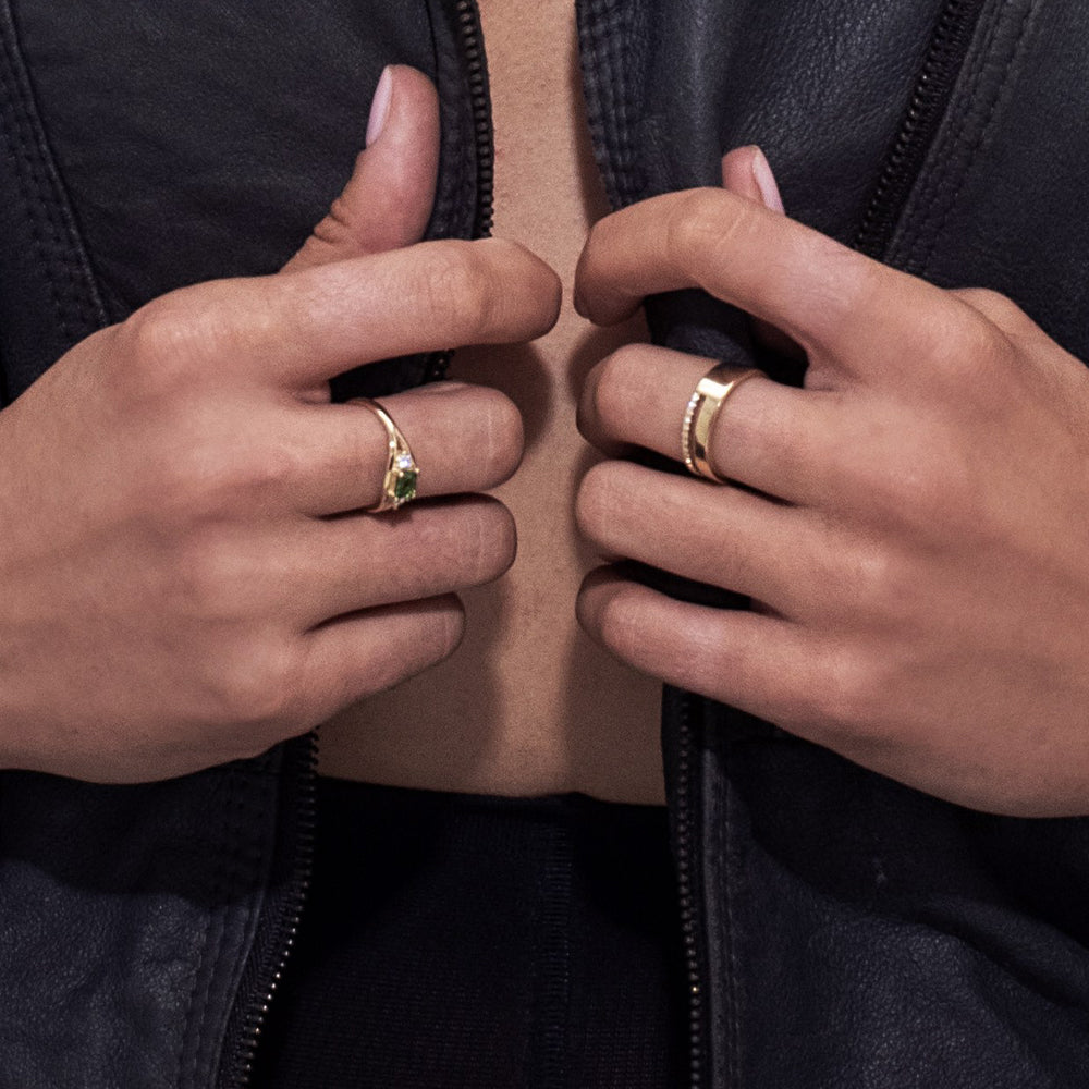 A double gold ring set with a row of diamonds and a smooth wide band