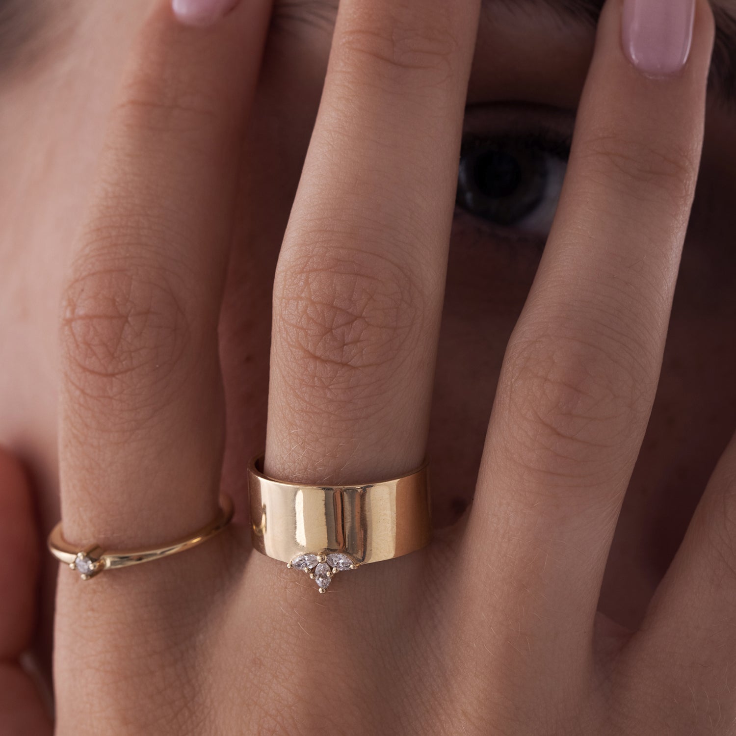 A delicate solitaire ring set with a diamond weighing 5 points