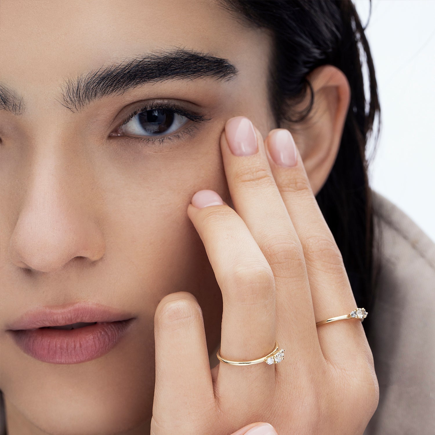 A delicate gold ring set with three white diamonds