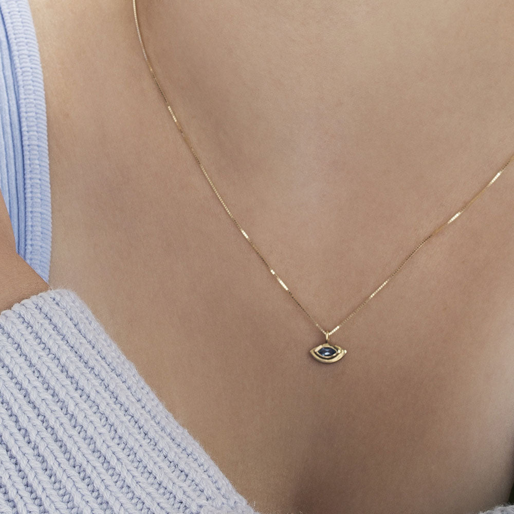 The evil eye pendant with a modern twist in aqua marine inlay