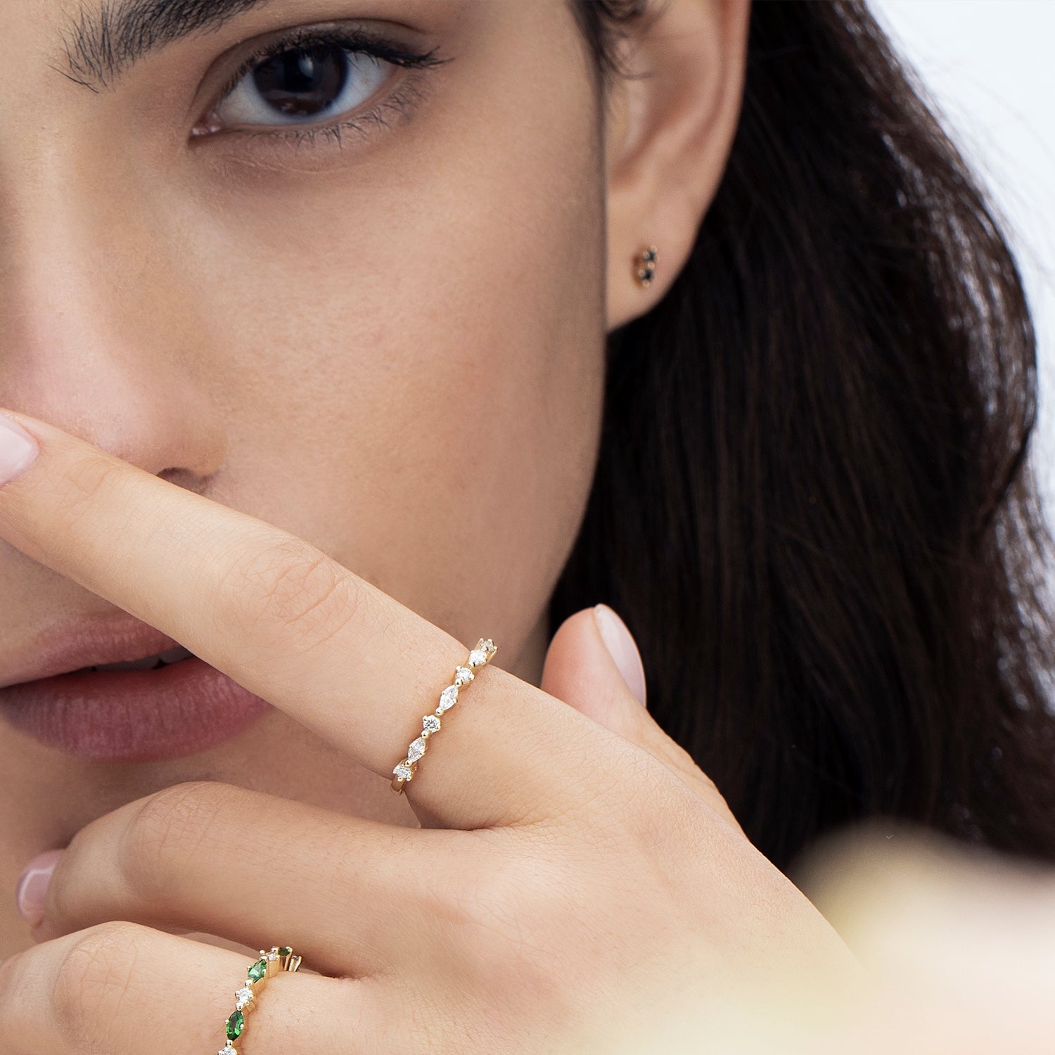 Tight gold earrings studded with two black diamonds
