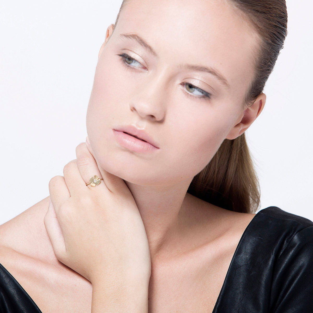 A gold and diamond flower ring with a delicate design