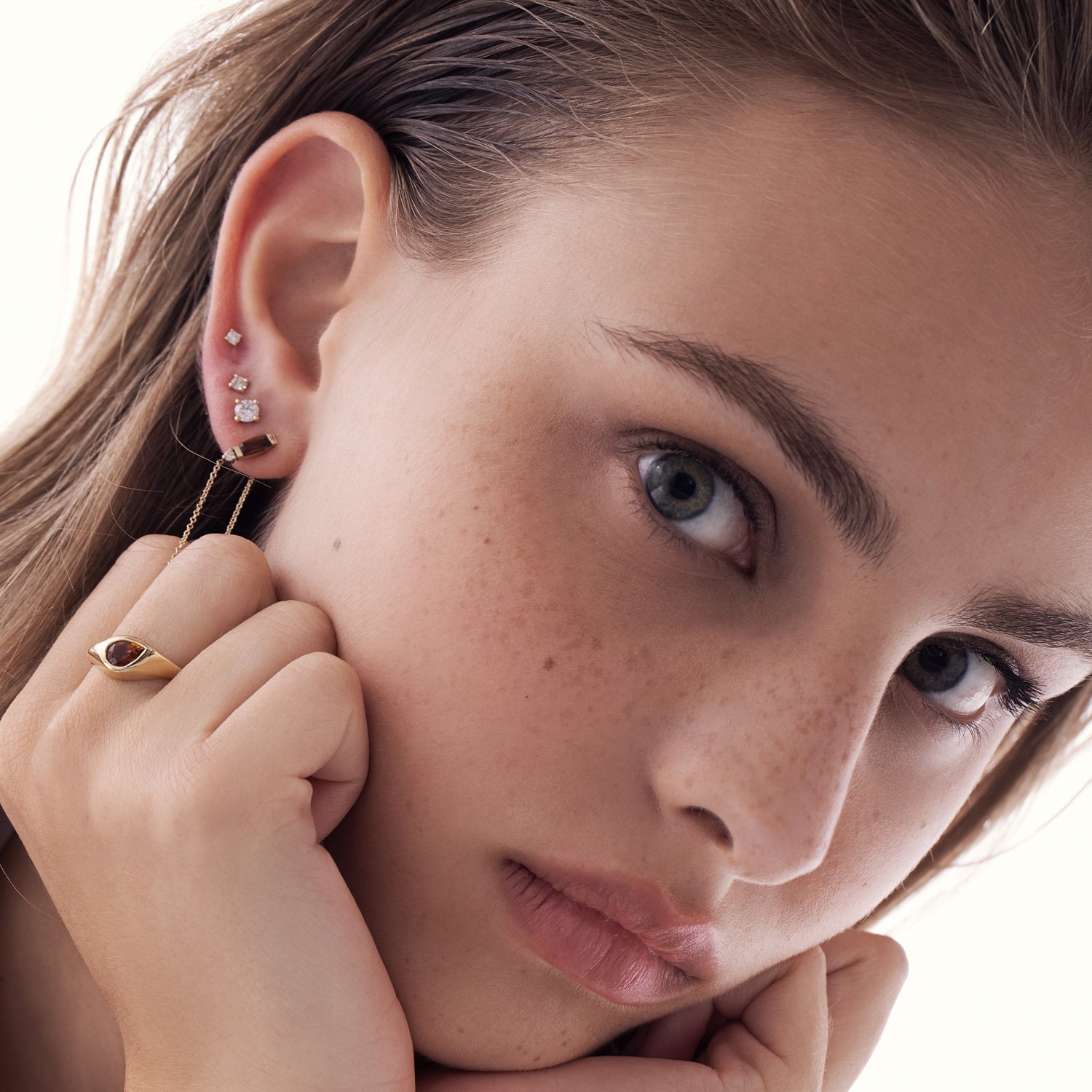 A special gold chain earring studded with gemstone, tourmaline and diamond