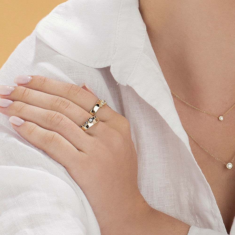 A wide gold ring with a special asymmetric setting of diamonds