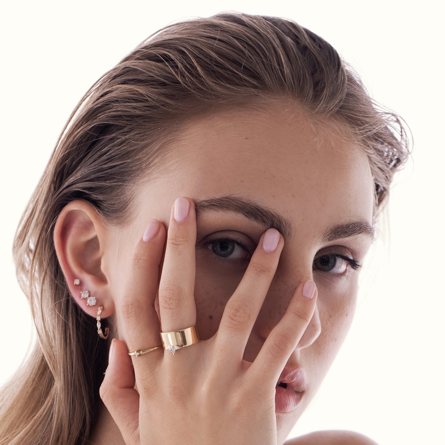 A delicate solitaire ring set with a diamond weighing 5 points