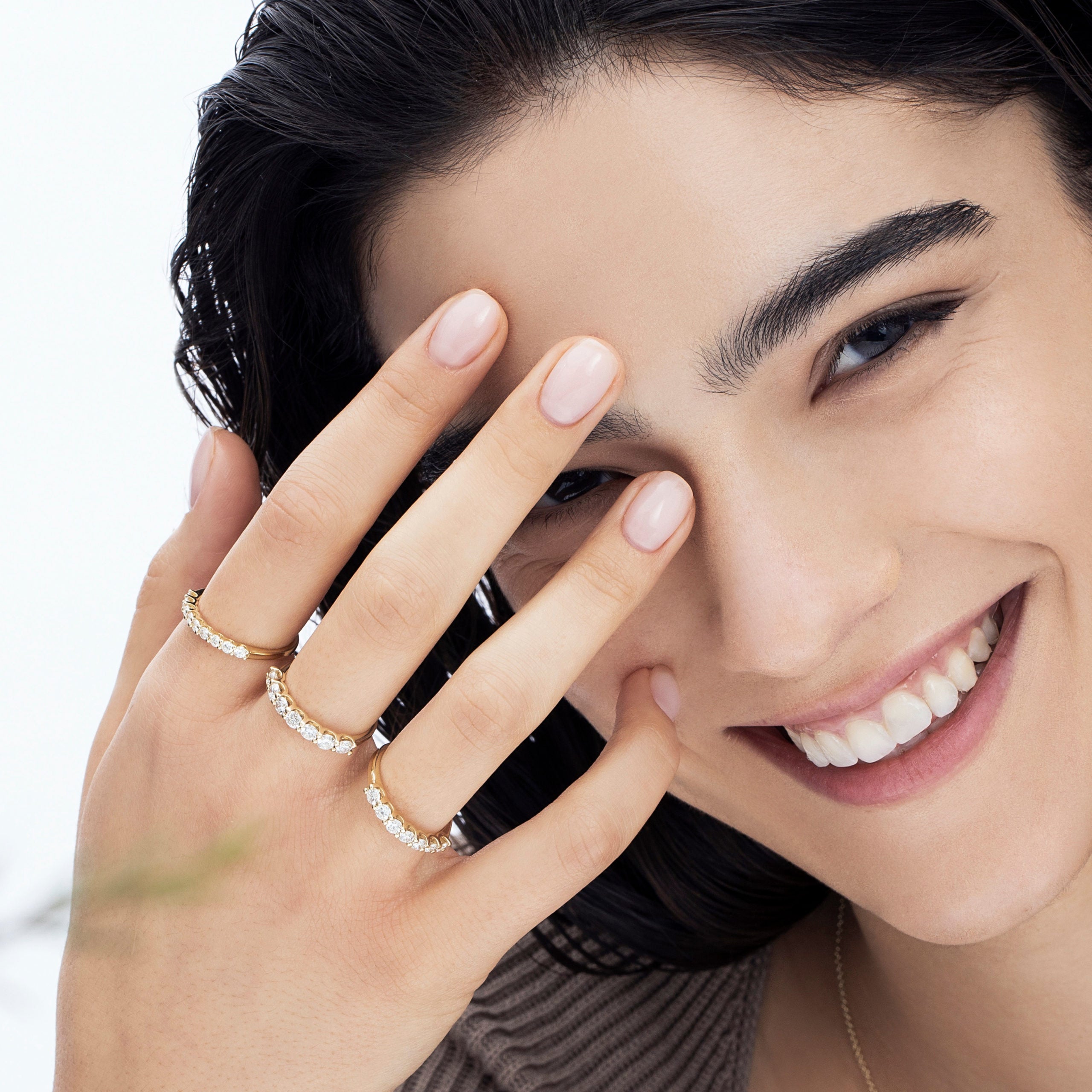 A gold ring set with 7 laboratory diamonds weighing 15 points per diamond