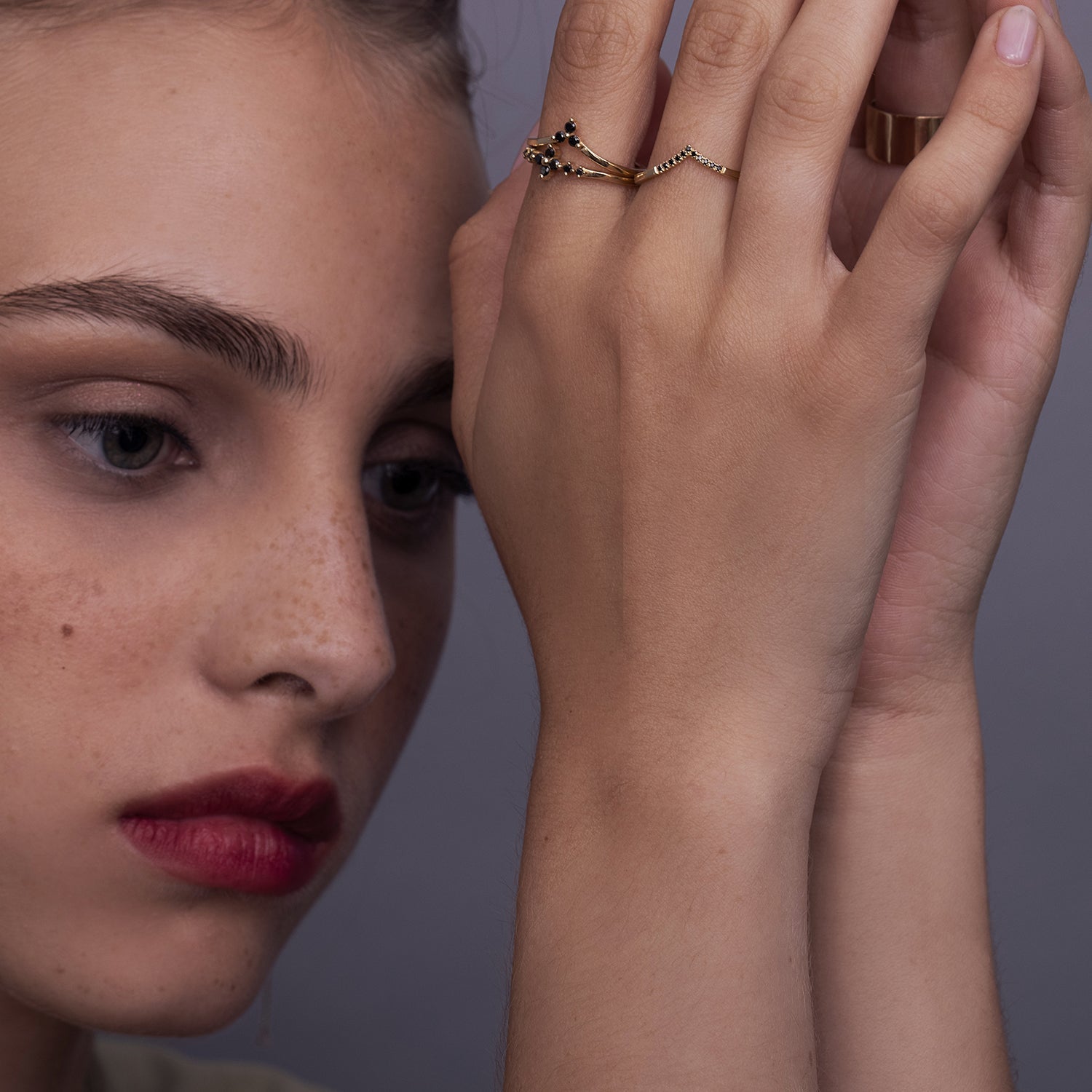 V-shaped gold ring set with 3 black diamonds