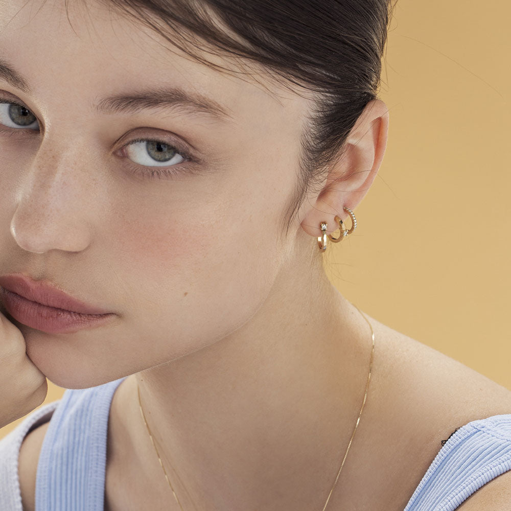 Classic small hoop earrings studded with white diamonds