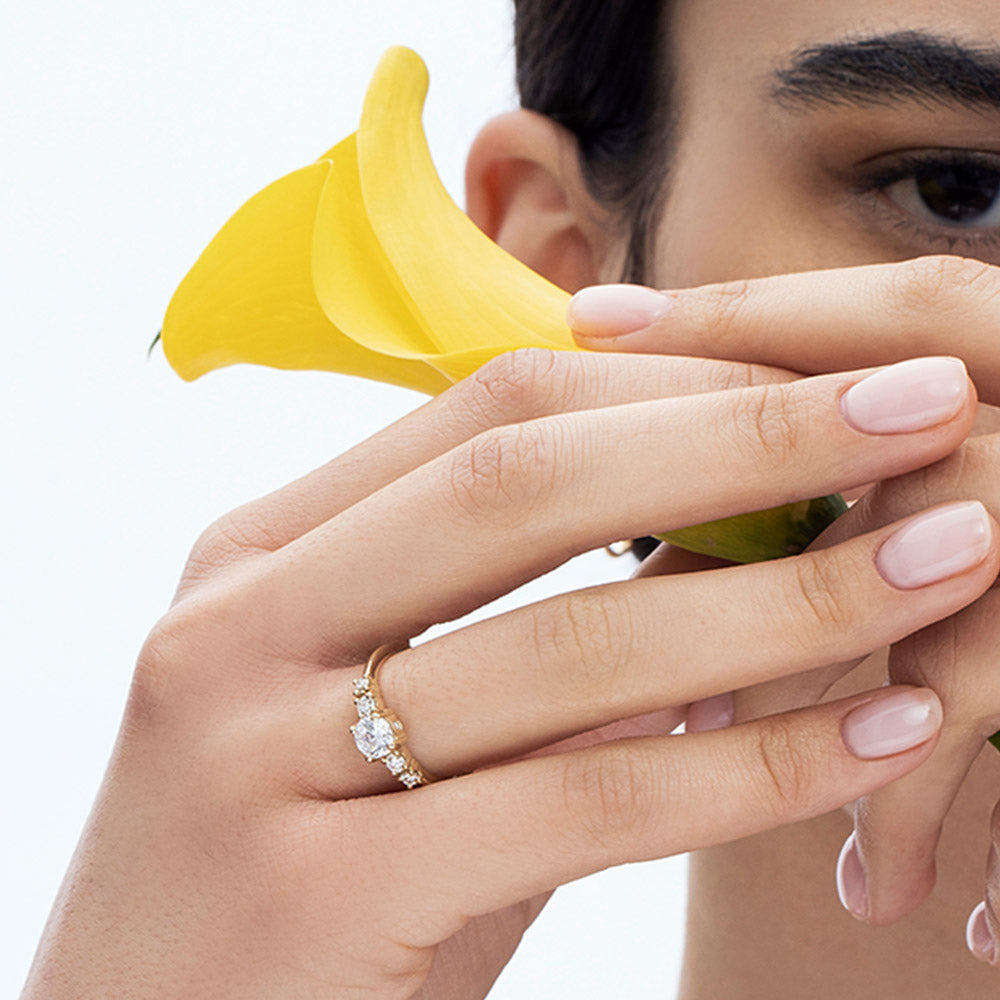 An engagement ring set with a central round lab diamond and 4 side lab diamonds
