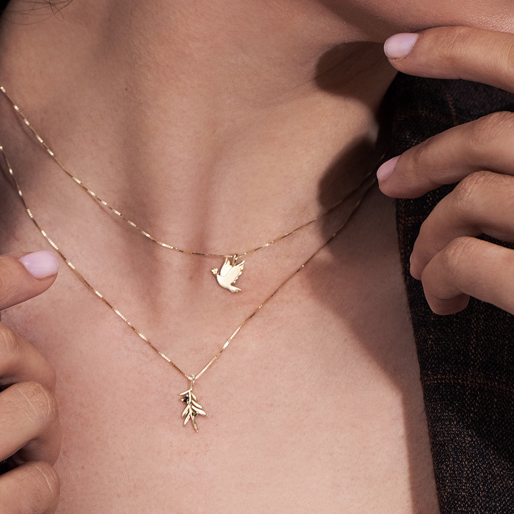 Gold necklace with an olive leaf pendant studded with tourmalines