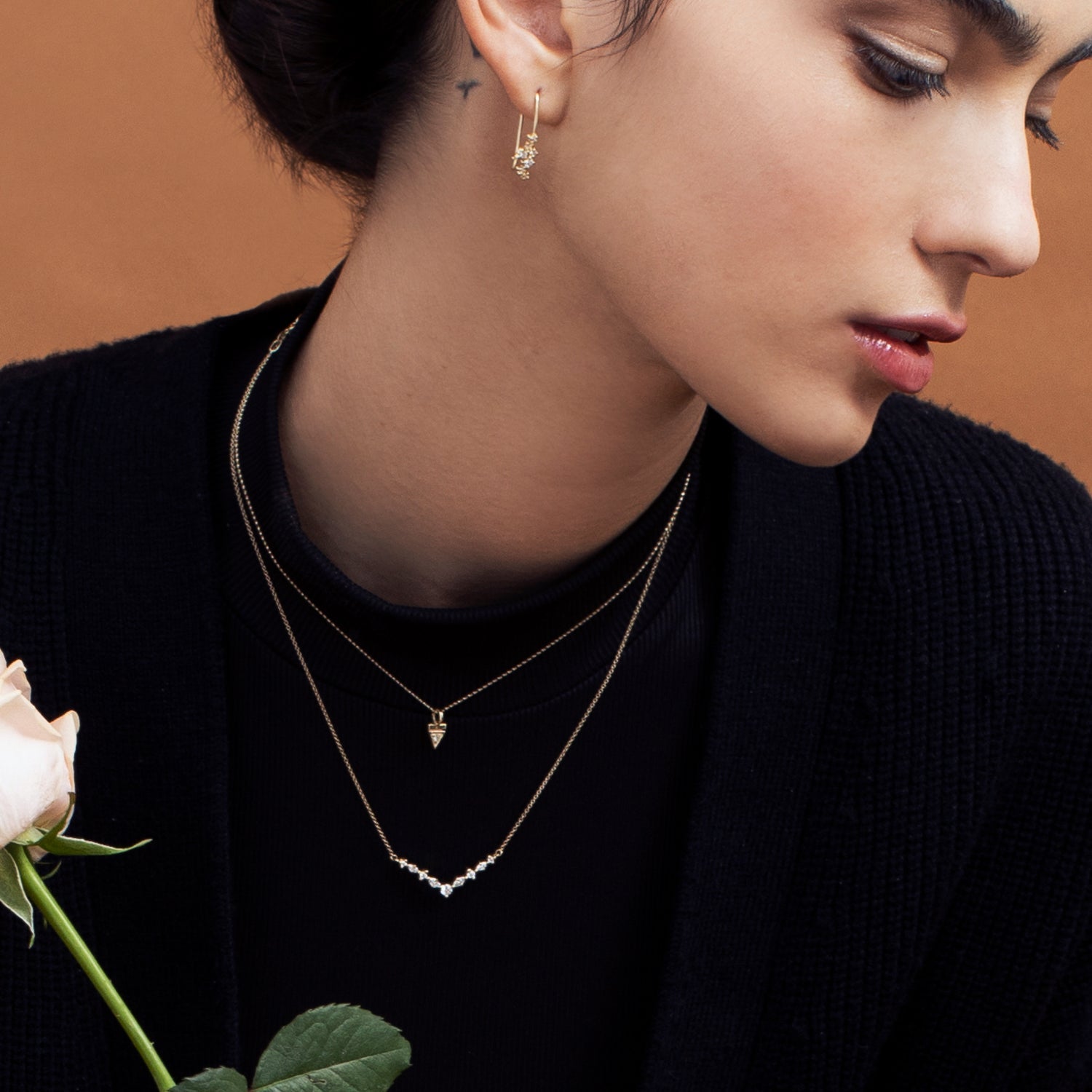 Hanging gold earrings studded with diamonds of varying sizes