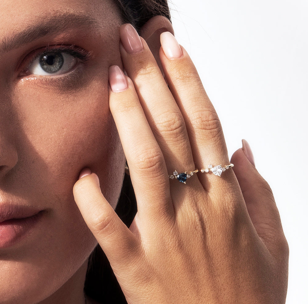 An engagement ring set with a trillion-cut sapphire and diamonds all around