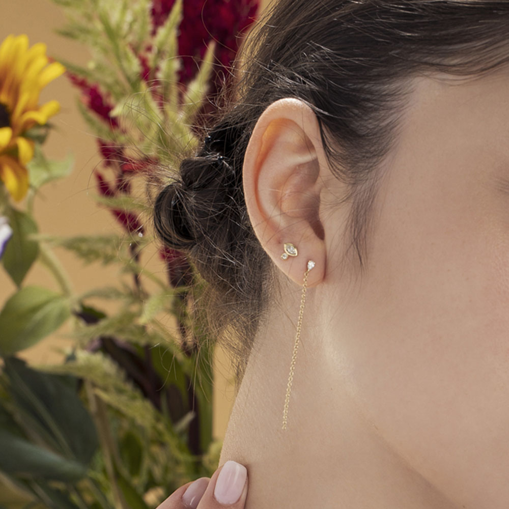 A single (!) special close-fitting earring set with a marquise-cut natural diamond (7 points) and a round-cut natural diamond with a ruby setting