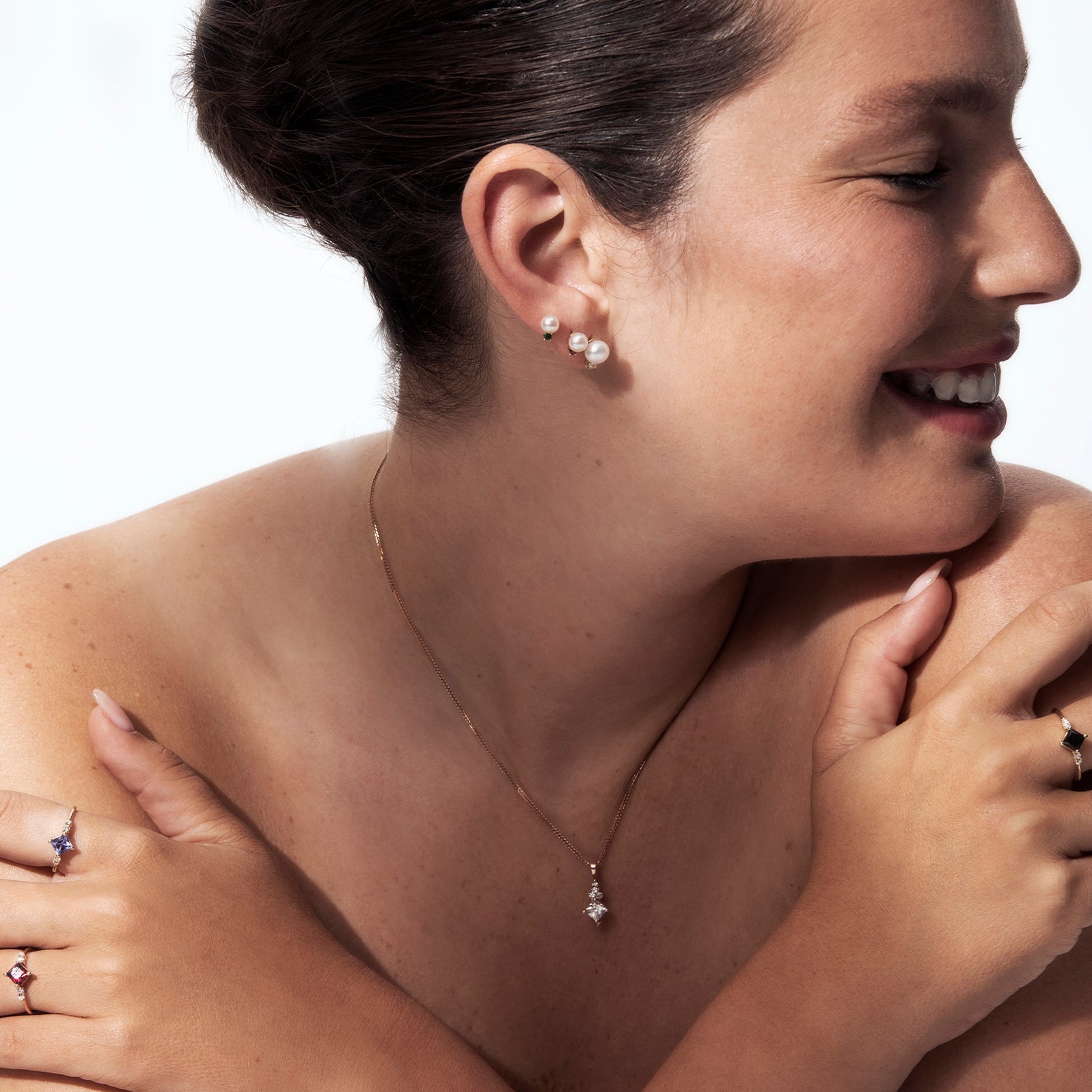 A gold ring set with princess-cut tanzanite and diamonds on the sides