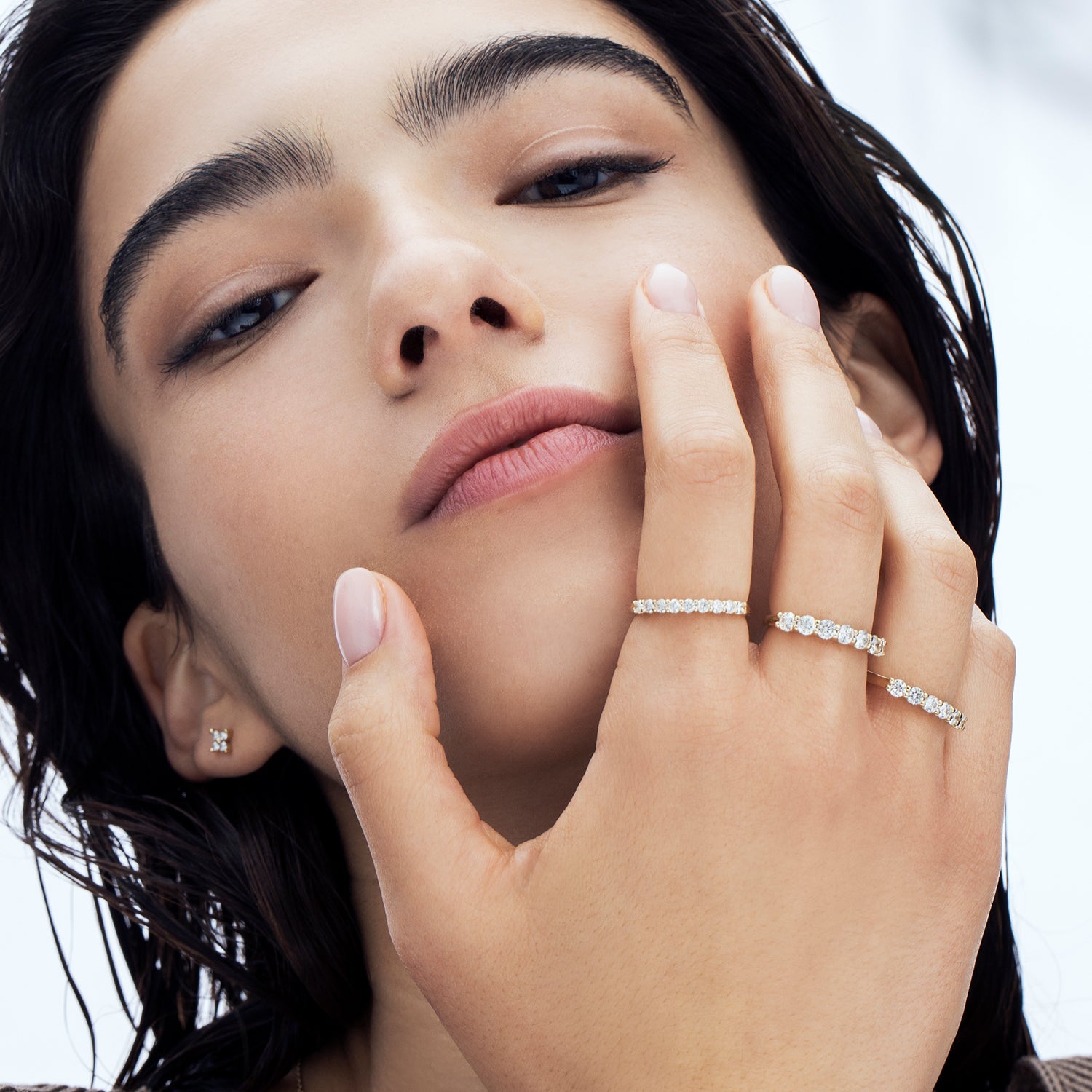 A gold ring set with 7 laboratory diamonds weighing 15 points per diamond