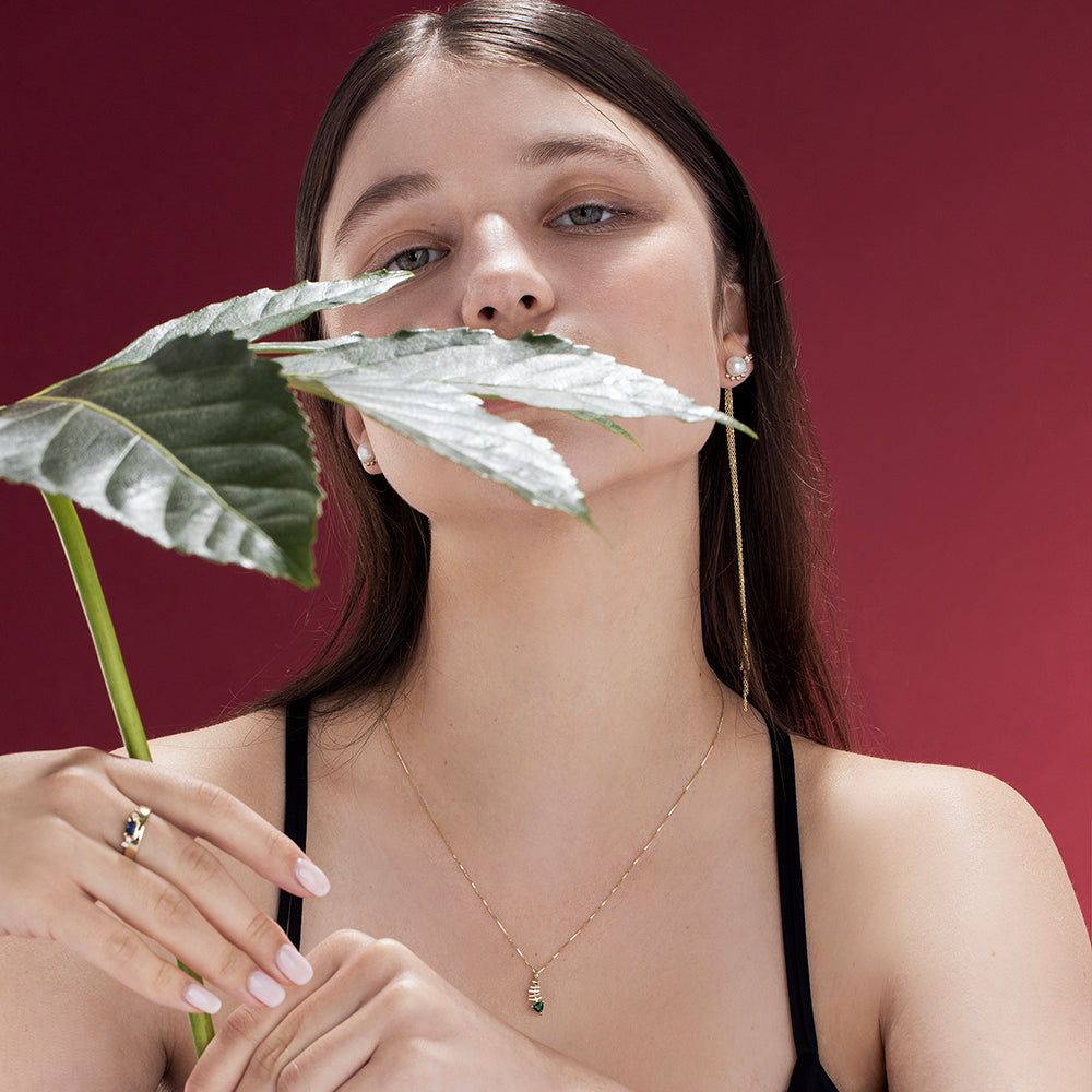 Gold necklace with fish pendant inlaid with tourmaline