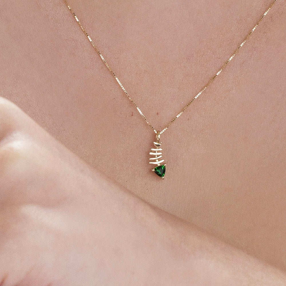 Gold necklace with fish pendant inlaid with tourmaline