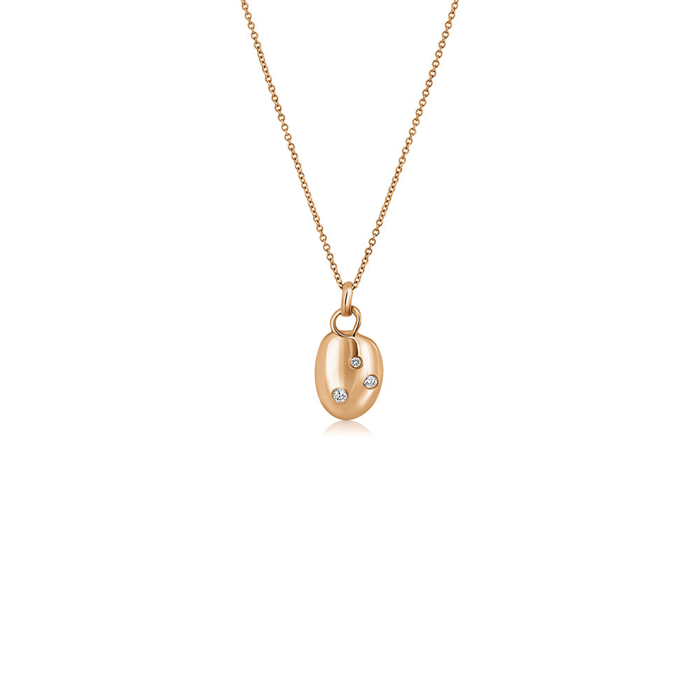 An amorphous gold chain set with three lab diamonds of varying sizes