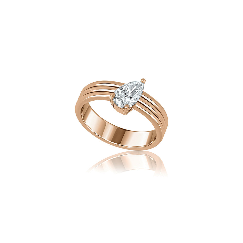 A wide gold ring set with a drop-cut lab diamond