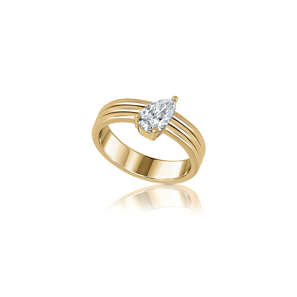 A wide gold ring set with a drop-cut lab diamond