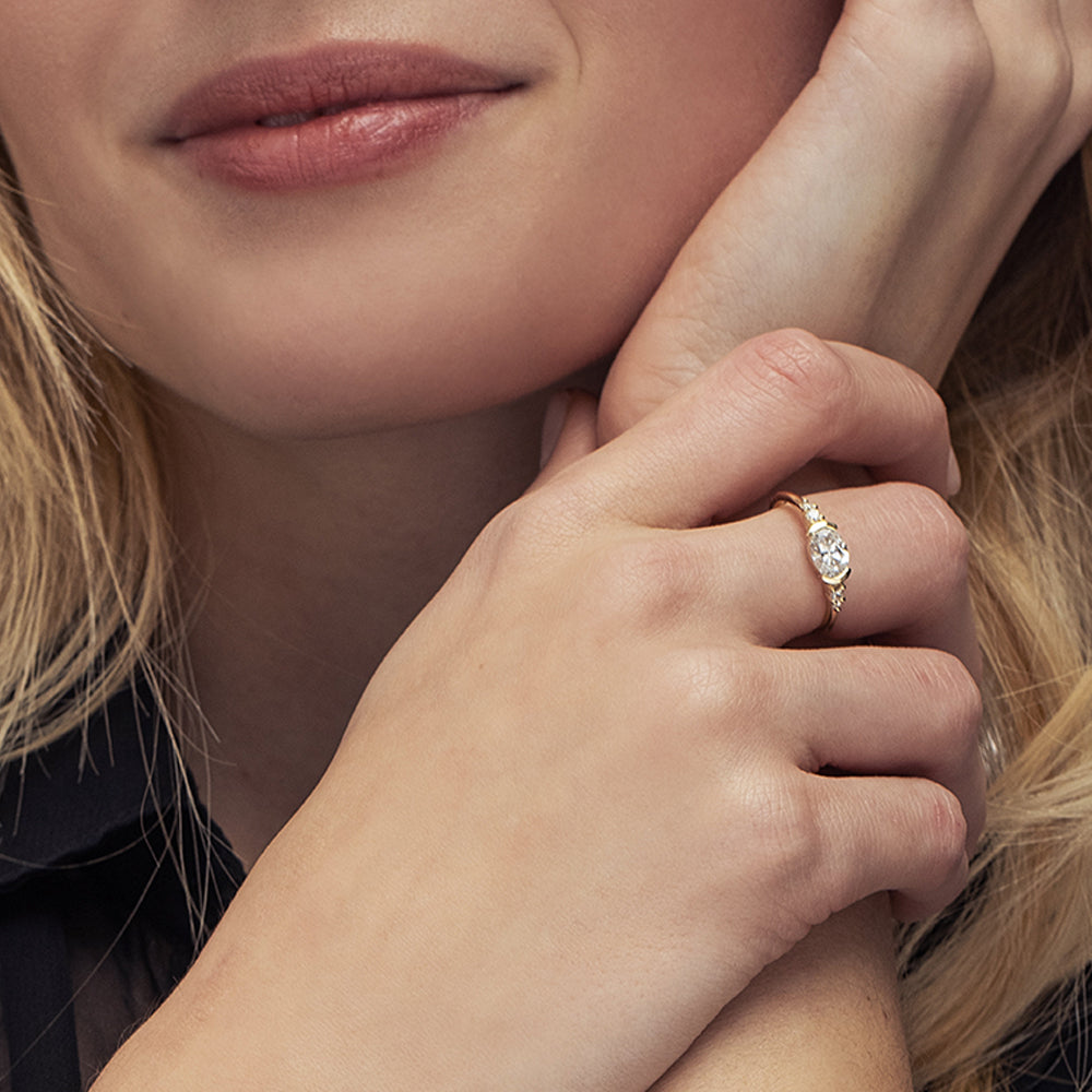 A unique engagement ring set with a laboratory diamond in a horizontal oval cut