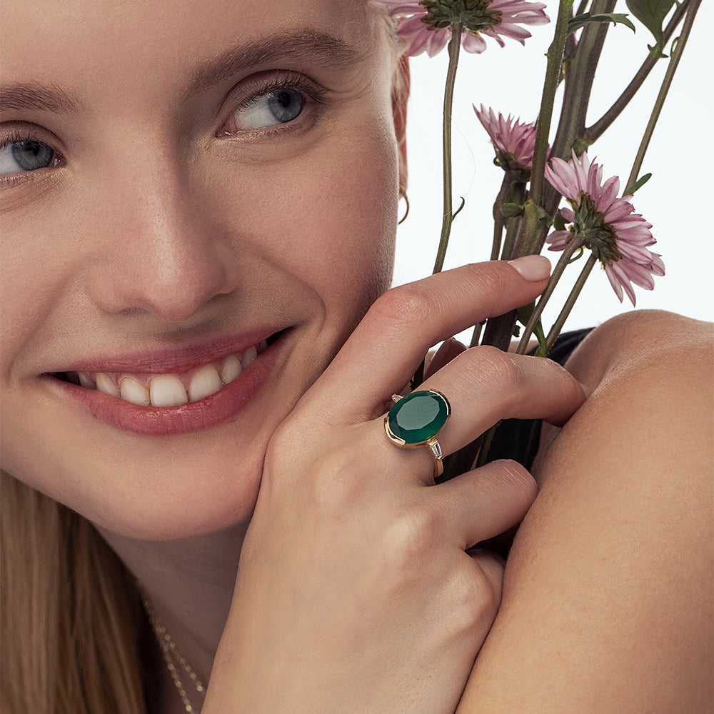 An impressive green onyx ring with an oval cut and laboratory diamonds