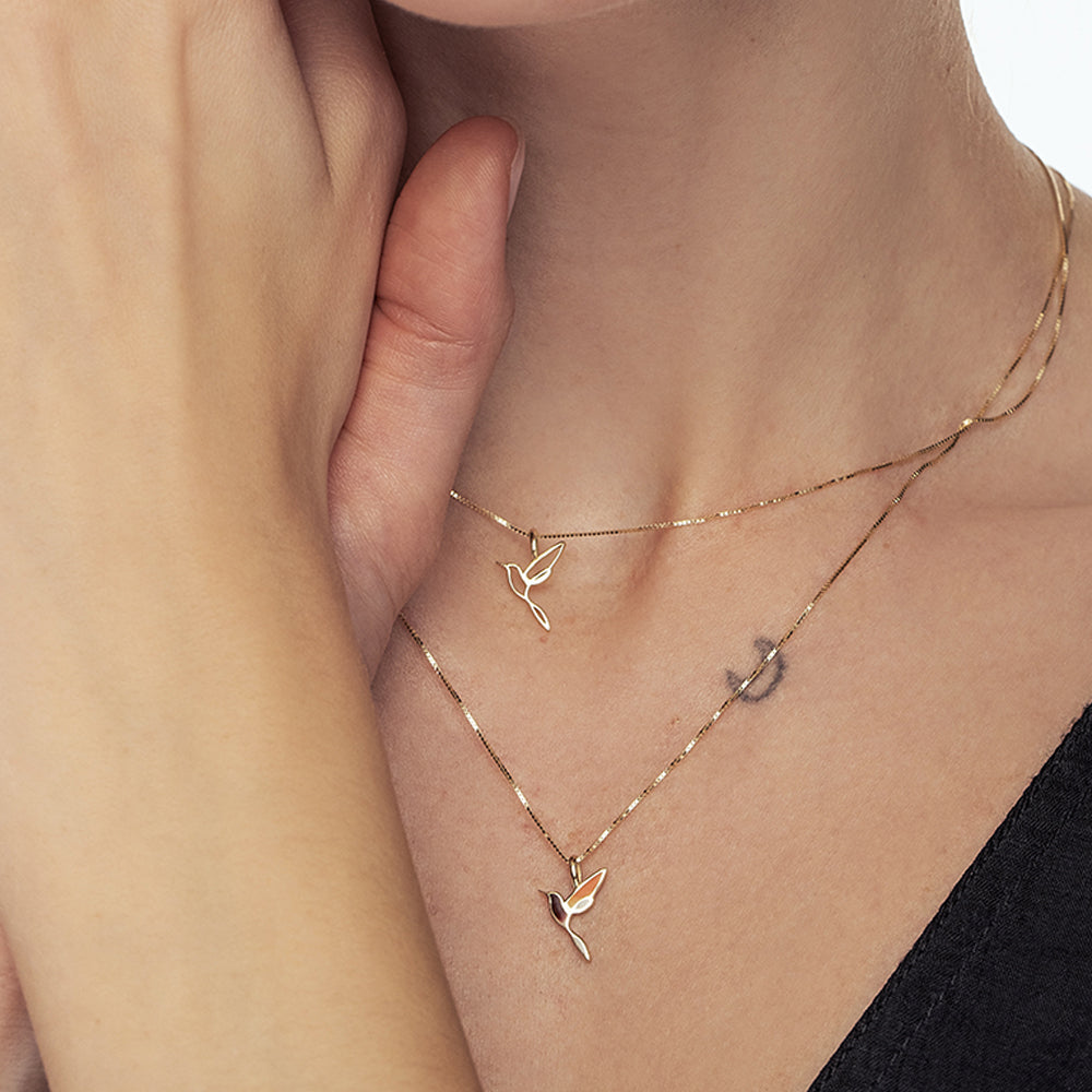 A special gold necklace with an enamel bird pendant