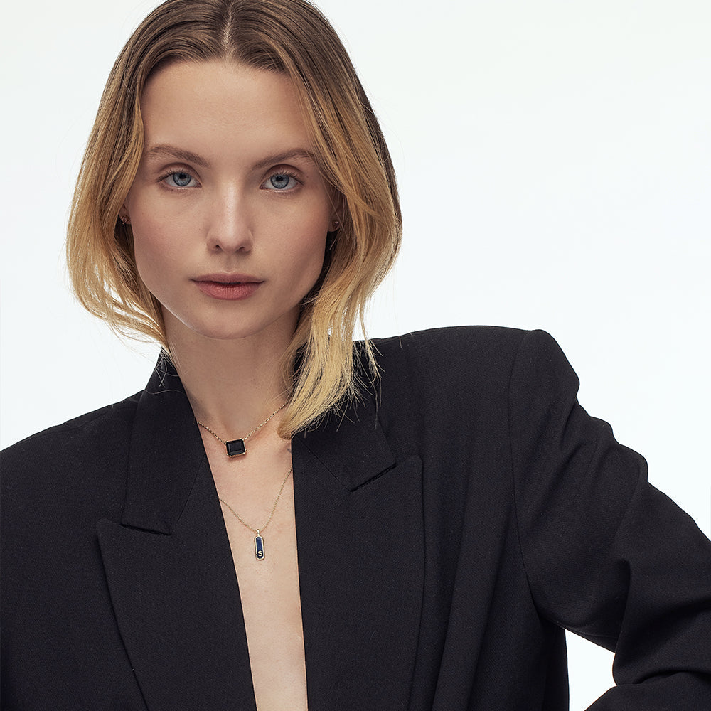 A gold necklace for a woman inlaid with a rectangular black onyx