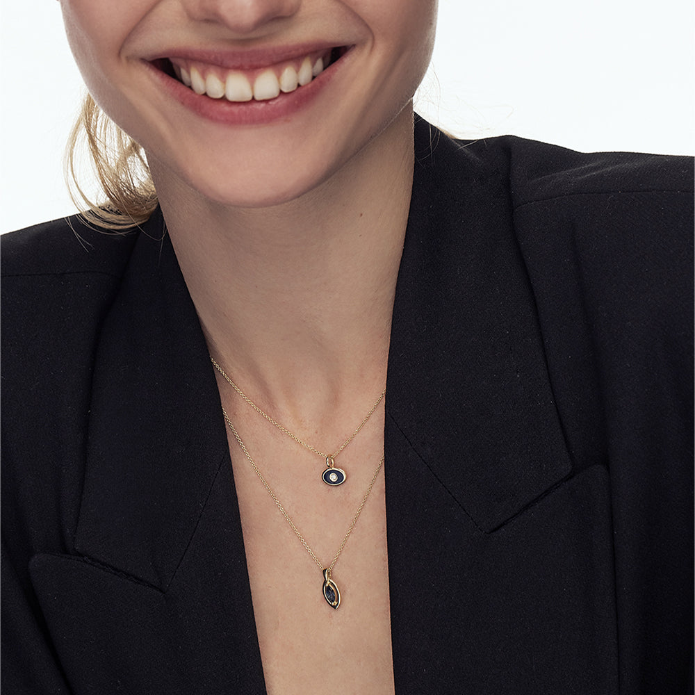 A gold chain with a modern evil eye pendant for men, inlaid with a marquise-cut sapphire