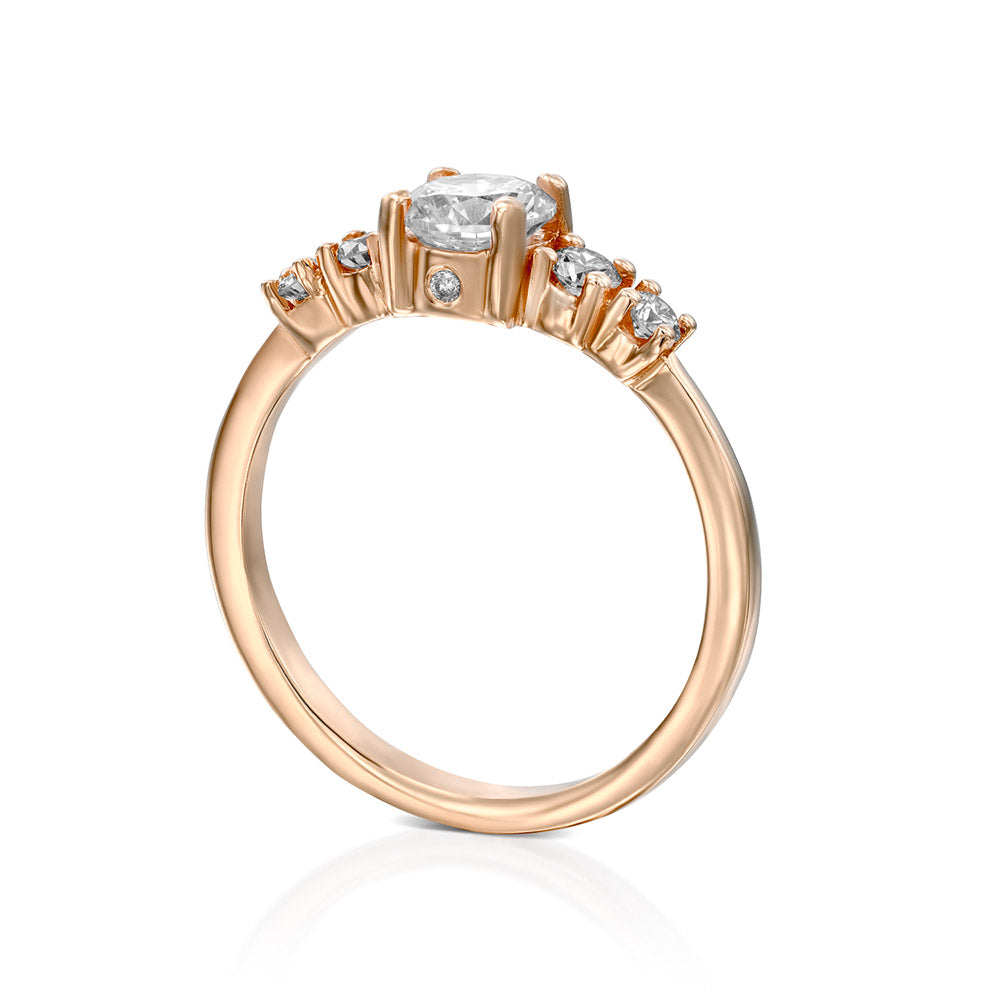 Engagement ring set with a central round diamond and 4 side diamonds