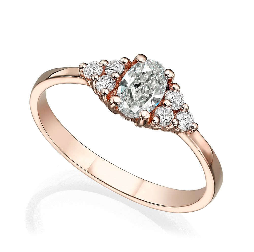 An engagement ring set with a central oval diamond and 6 side diamonds