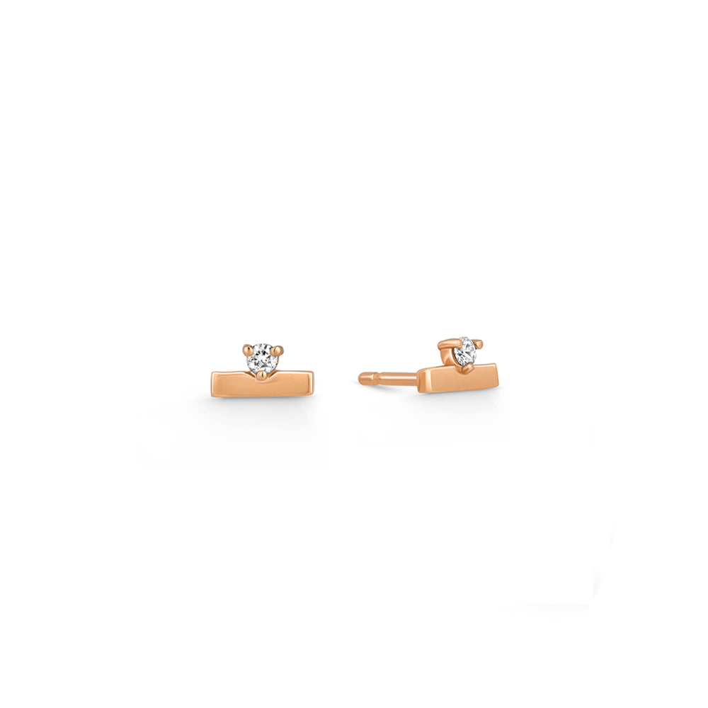 Gold earrings, tight, small, in the form of a stripe, set with a diamond