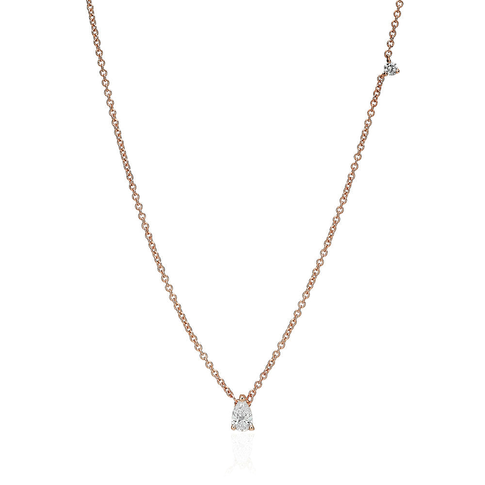A gold chain set with a drop-cut diamond and a round diamond on the side