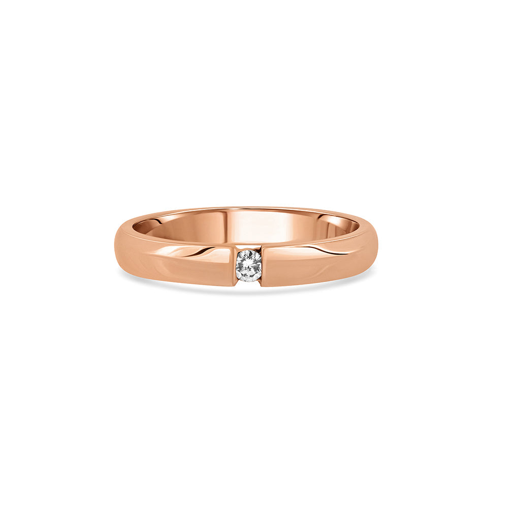 A gold ring set with a round diamond weighing 5 points