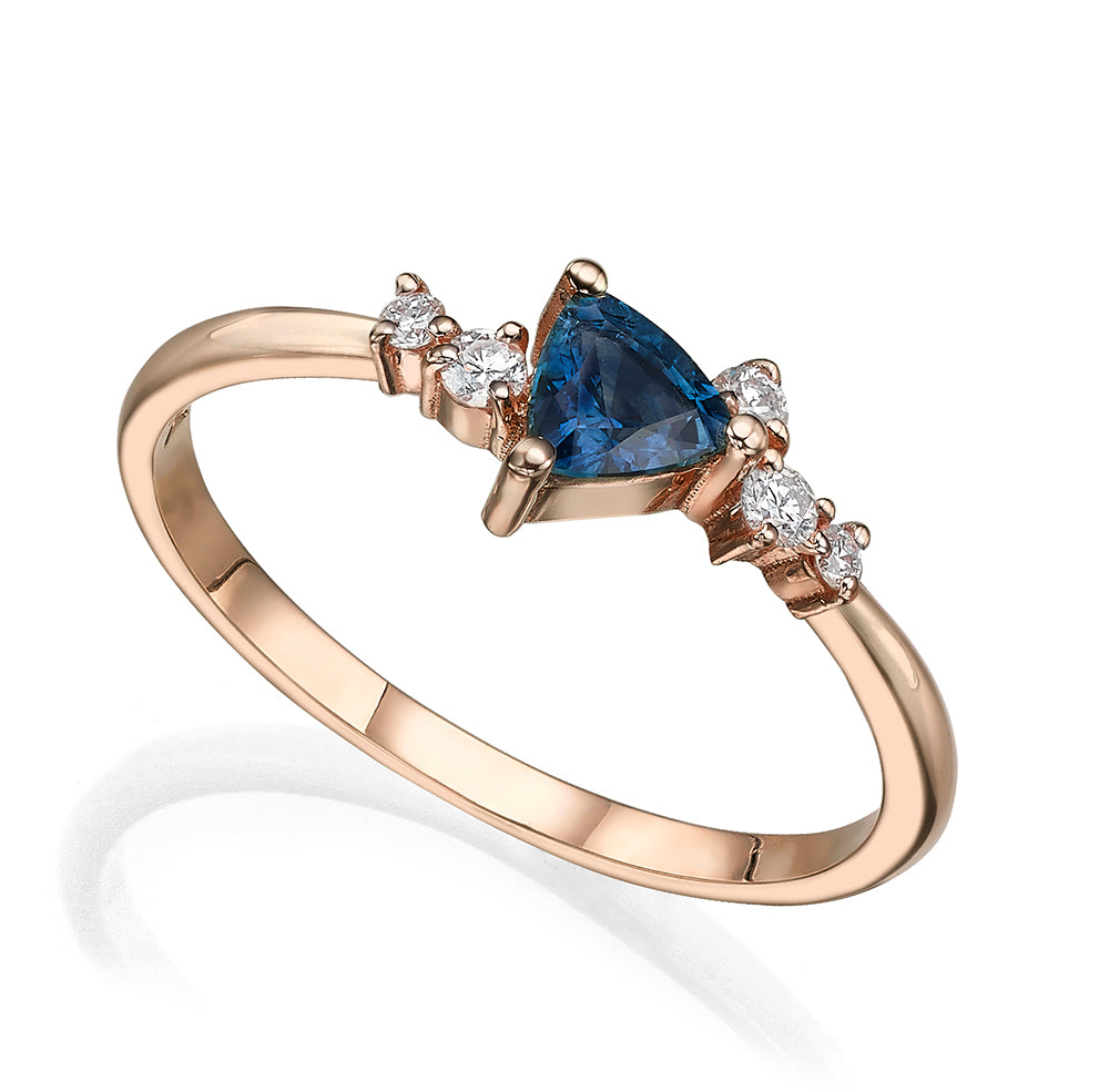 An engagement ring set with a trillion-cut sapphire and diamonds all around
