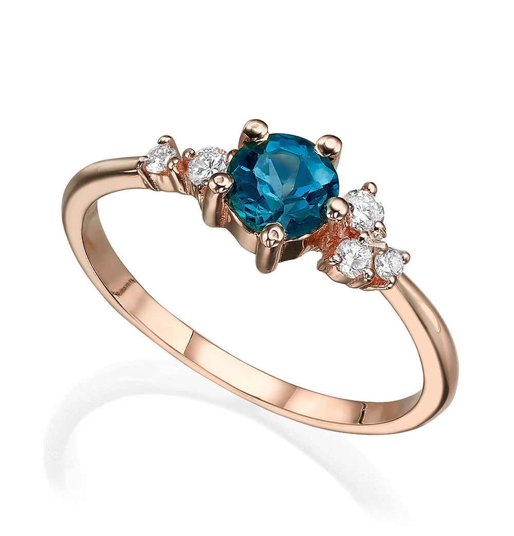 An engagement ring set with London blue topaz and small one-centimeter diamonds