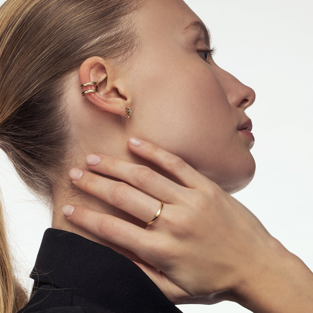 A thin wedding ring with a twist in the front part
