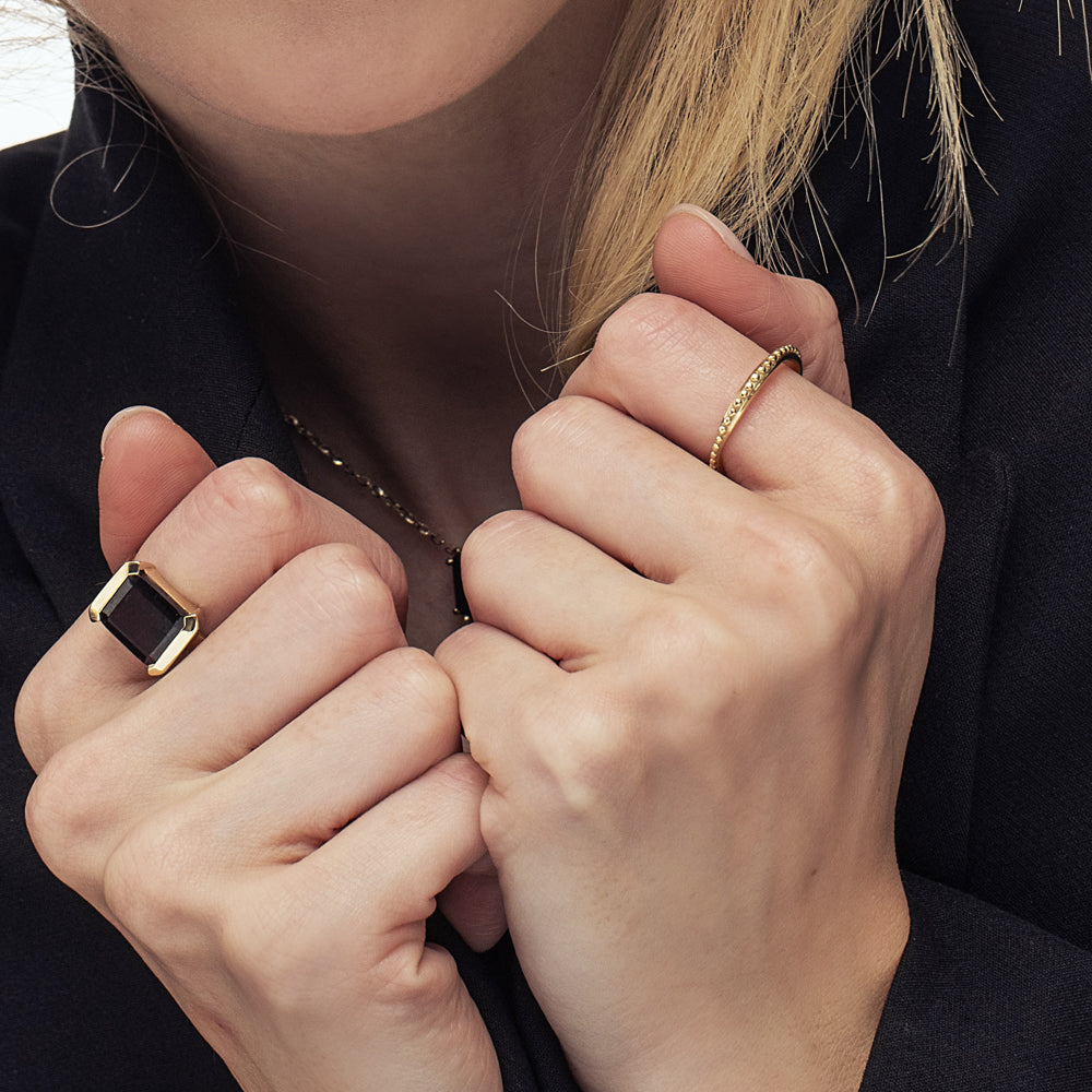 Asymmetric wedding ring decorated with a gold ball